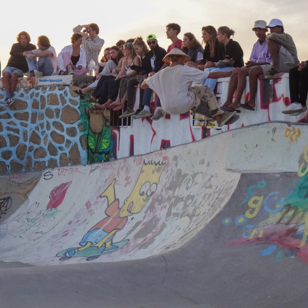 Taghazout skatepark crowd at dawn with skaters