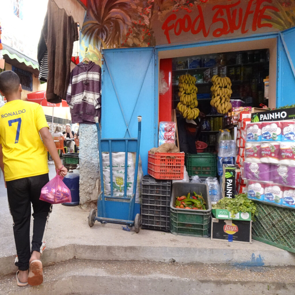 Kid walking in the colorfull street of Taghazout, Morocco